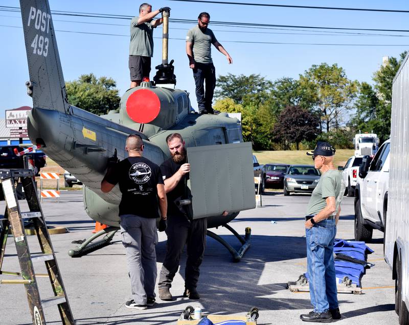 Crews from Midwest Aerospace prepare a Huey helicopter monument on Sept. 30 in Baxter.
