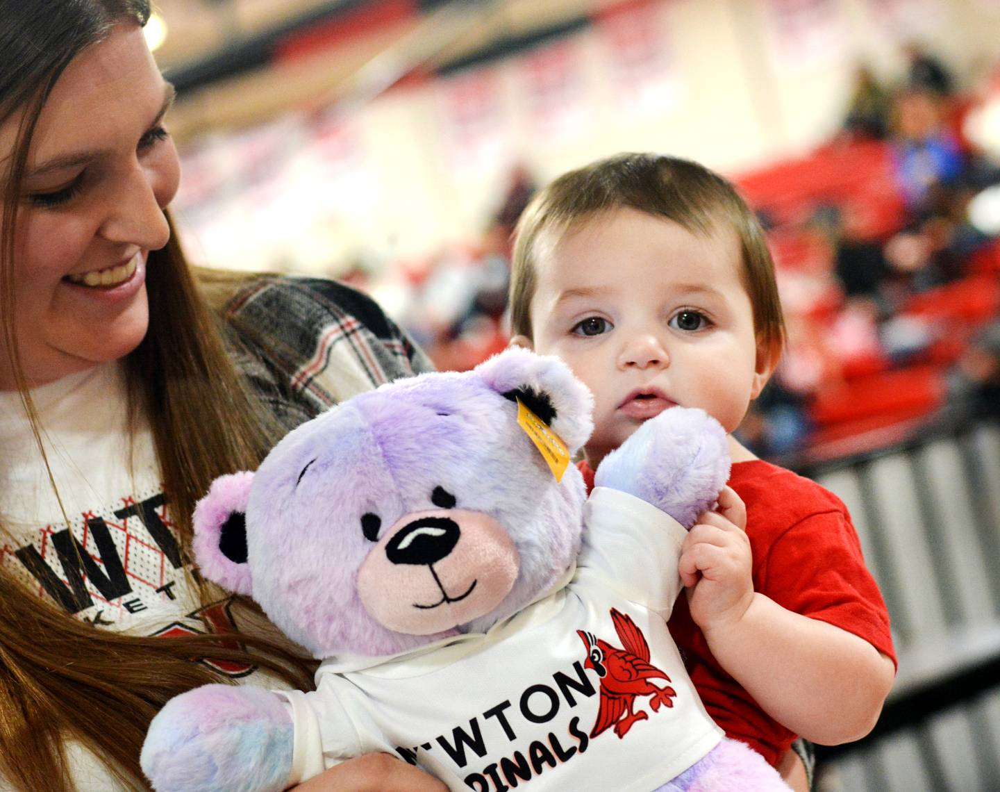 An 8-month-old Hazel Bennett holds onto her newly made teddy bear during a fundraiser for the United Way of Jasper County and Newton Pacesetters on Dec. 12 at Newton High School.