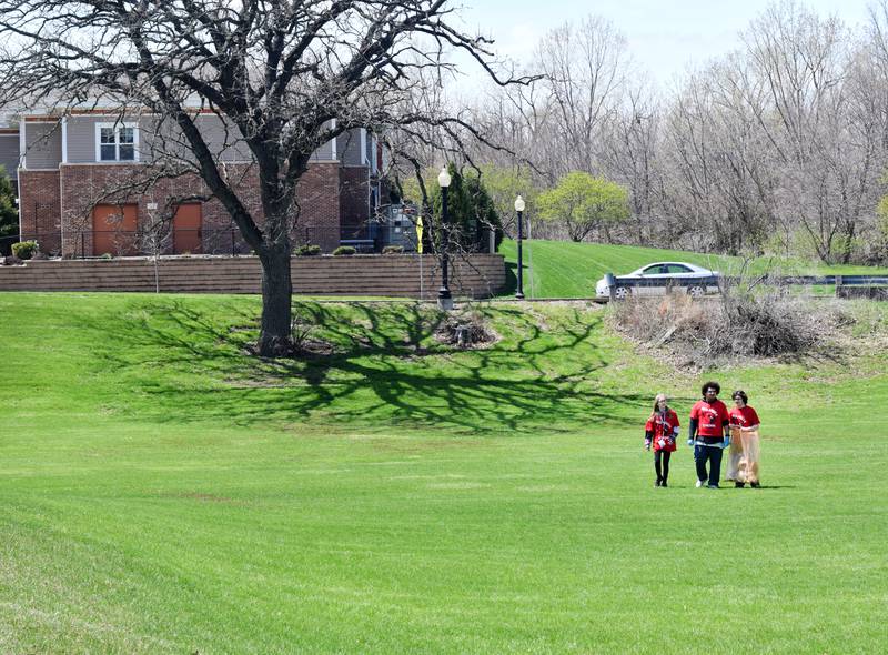 Students clear Sunset Park of trash and debris during Red Pride Service Day on May 4 in Newton.