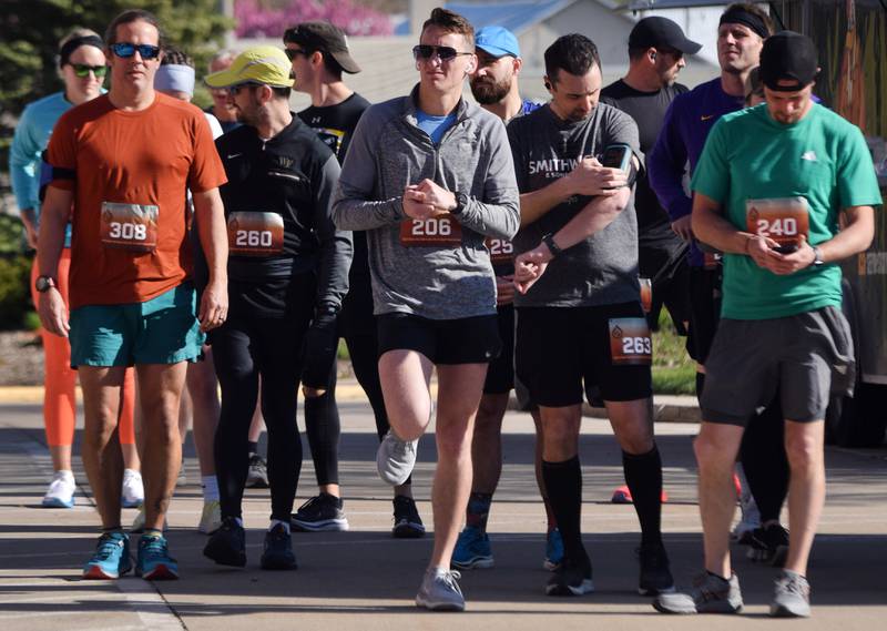 Runners, walkers and young bikers take off for the Run For Her Life 5K organized by nonprofit Phoenix Phase Initiative on April 29 at Legacy Plaza in Newton.