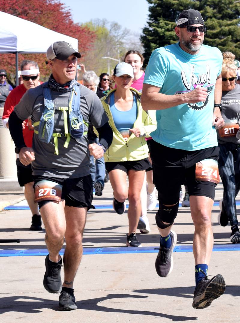 Runners, walkers and young bikers take off for the Run For Her Life 5K organized by nonprofit Phoenix Phase Initiative on April 29 at Legacy Plaza in Newton.