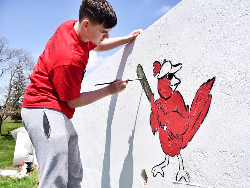 Students paint a mural during Red Pride Service Day on May 4 at Sunset Park in Newton.