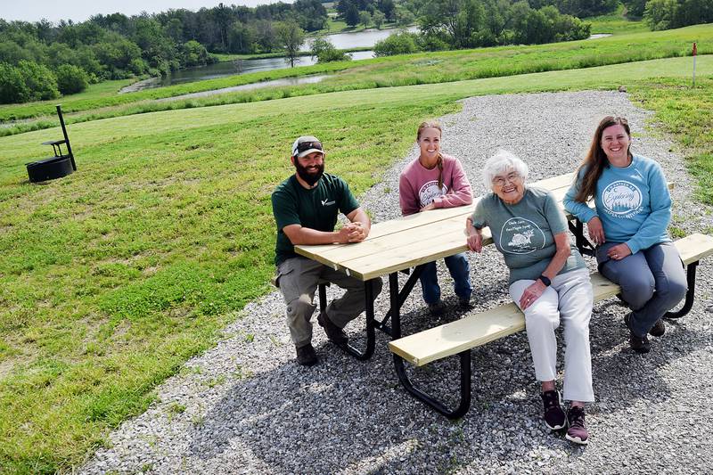 Jasper County Conservation staff and board members pose for a picture at the Bison Ridge Campground, which features a number of modern-style campsites.
