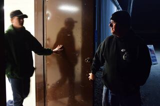 Michael Wood, a Libertarian candidate running for Iowa House District 38, holds the door open for his son after voting in his precinct at the Jasper County Fairgrounds on Nov. 8 in Colfax.
