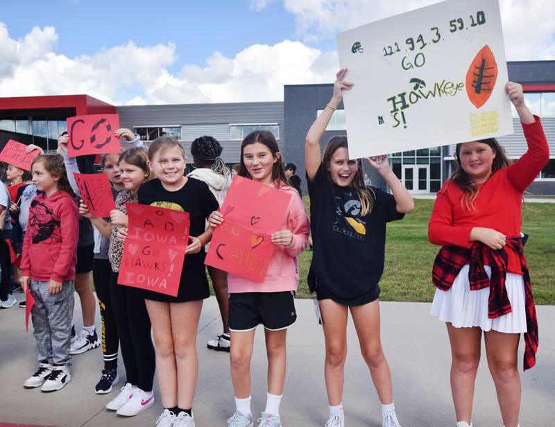 Students wearing Cyclone and Hawkeye apparel pose for pictures on Sept. 4 outside Berg Middle School. The whole study body was invited to welcome RVTV to town.