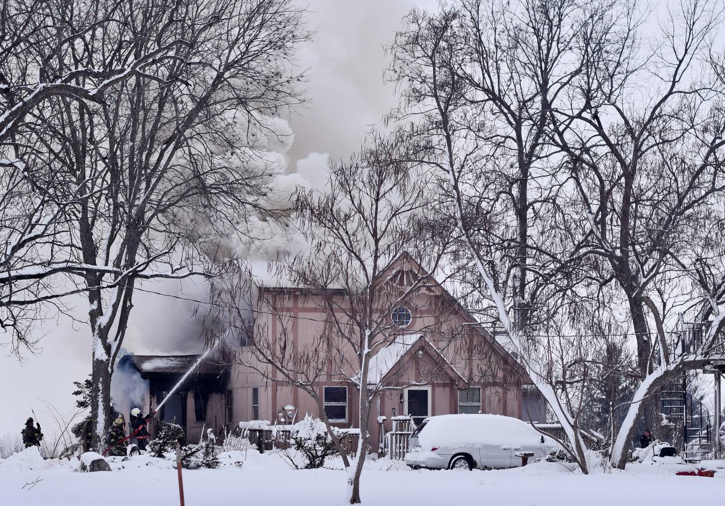 Newton firefighters attempt to dose the flames of a home that caught fire Jan. 11 near the 1600 block of East Seventh Street South.
