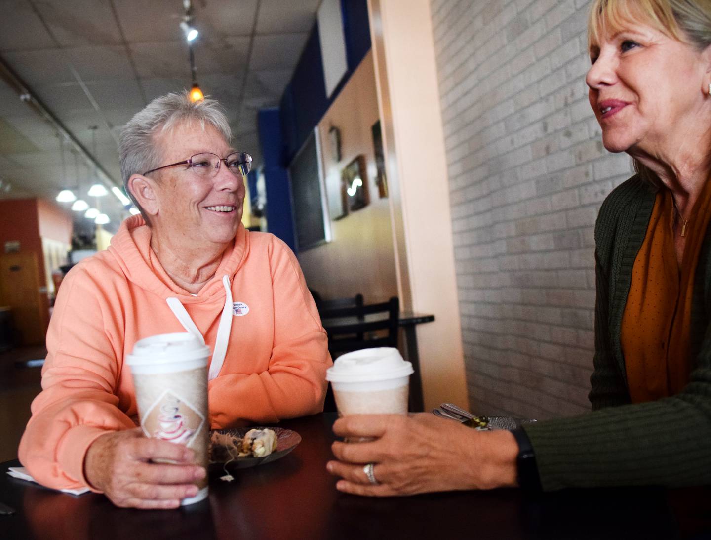Bev Price, a Democratic candidate running for a seat on the Jasper County Board of Supervisors, drinks tea with friend Pat Wallace inside Uncle Nancy's Coffee House on Nov. 8 in Newton.