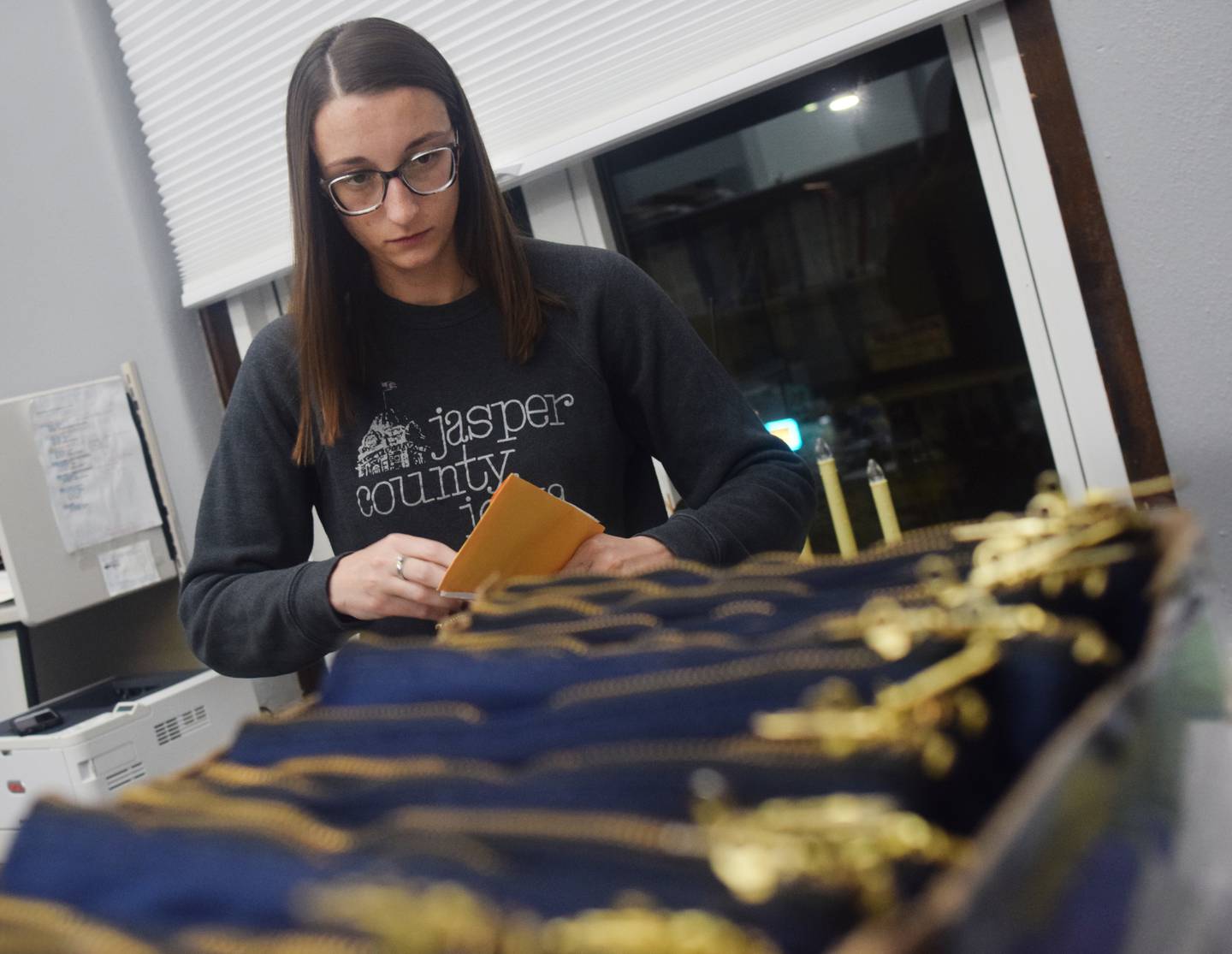Taylor Springer, deputy auditor of elections for Jasper County, opens the final blue bag that contains the poll data for Election Day results.