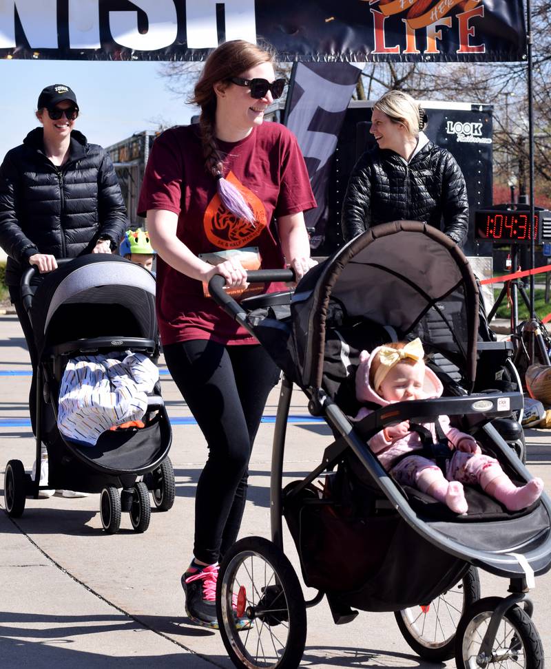 Runners, walkers and young bikers take off for the Run For Her Life 5K organized by nonprofit Phoenix Phase Initiative on April 29 at Legacy Plaza in Newton.