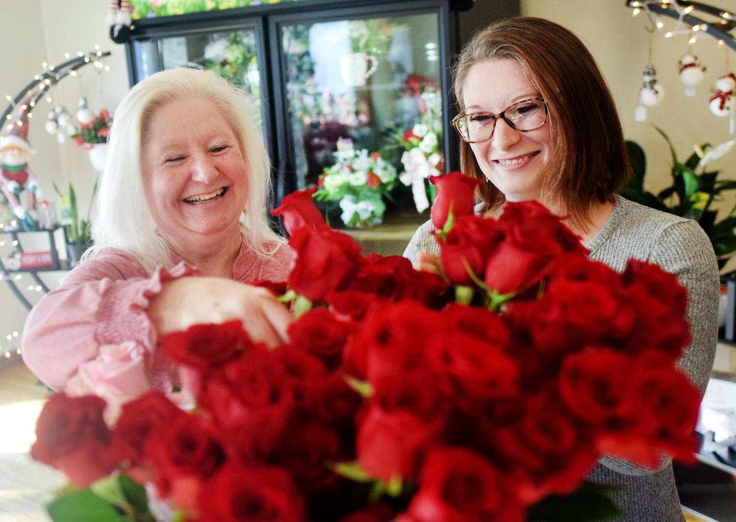 Jennifer Zimmerman, owner of Blooms by Design, and daughter Jerrica Pietz arrange roses for sale at the new flower shop, which opened this past week in Newton.