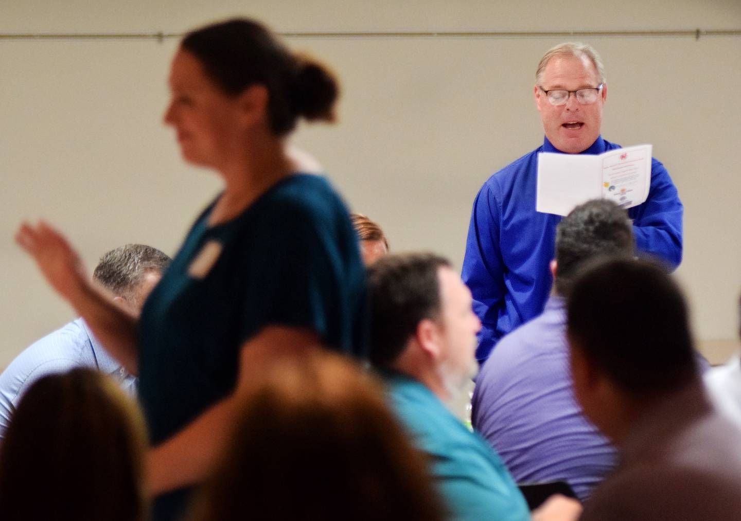 Newton High School Principal Bill Peters introduces a new teacher during the Greater Newton Area Chamber of Commerce's New Teacher Luncheon on Aug. 10 at the DMACC Newton Campus.