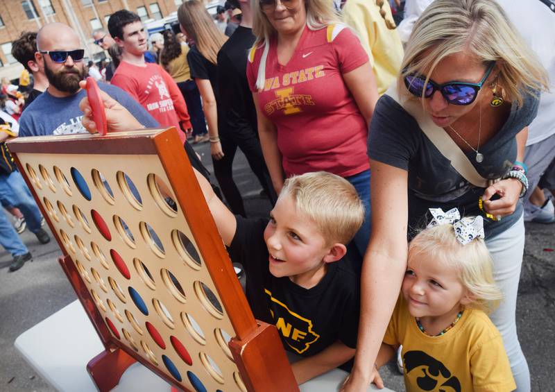 Young Hawkeye and Cyclone fans participate in games during RVTV celebrations on Sept. 4 in downtown Newton.