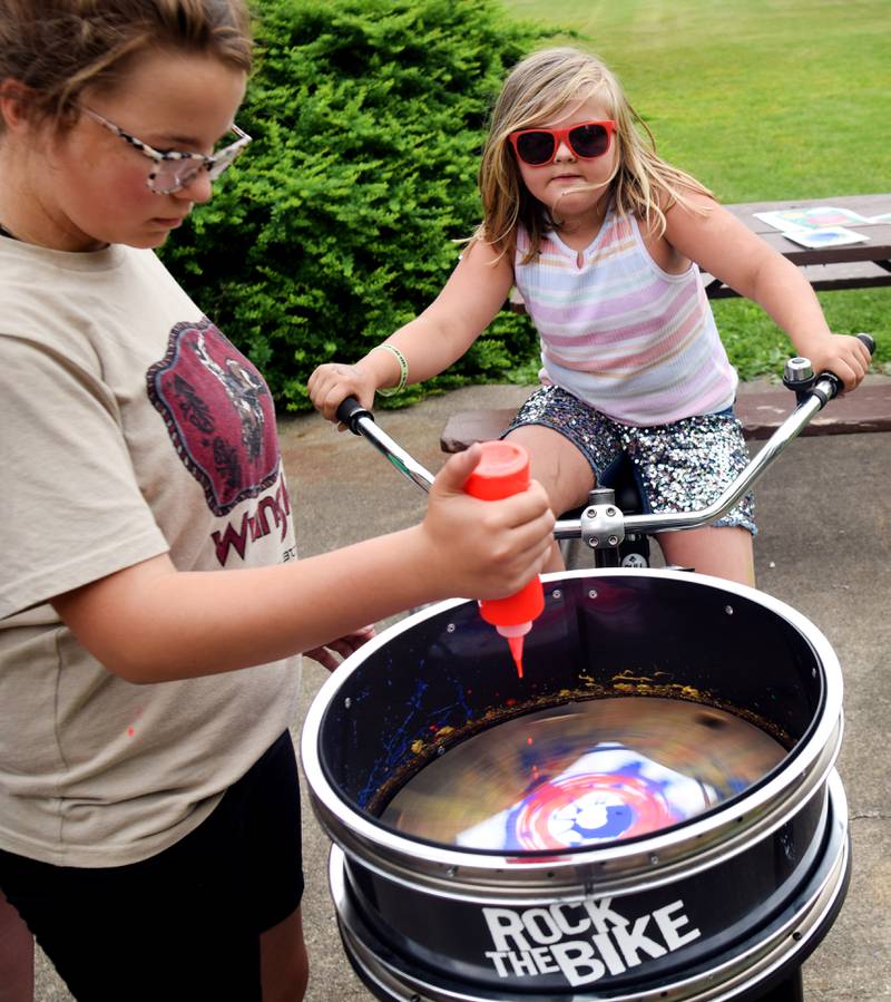 Iowa State University Extension and Outreach hold a spin art bike activity during Newton Fest on Saturday, June 10 at Maytag Park.