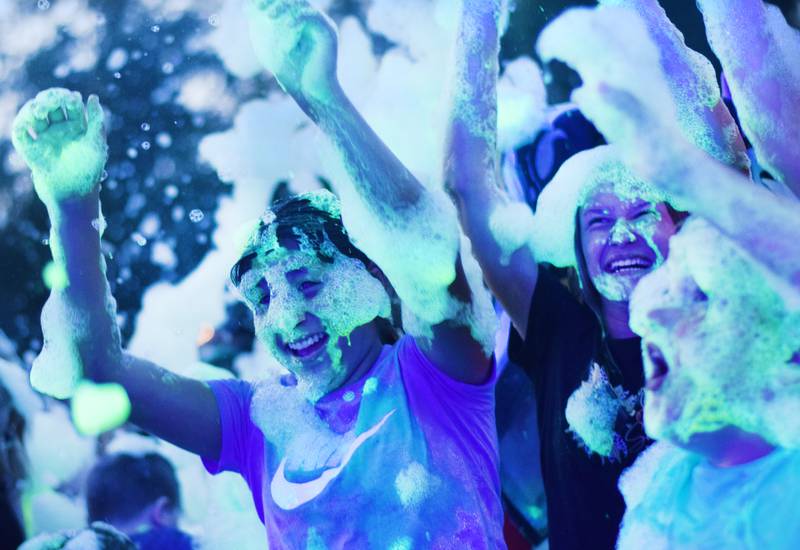 Kids participate in Driving Cap Entertainment's UV Glow Foam Party during Newton Fest on June 9 in Maytag Park in Newton.