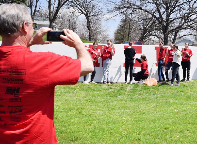 Students paint a mural during Red Pride Service Day on May 4 at Sunset Park in Newton.