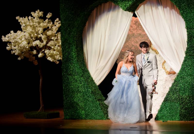 High schoolers pose for photographs before and after entering the auditorium for prom night on Aug. 15 at the Newton High School. Cardinals met for photos at a heart-shaped display on the stage before enjoying the festivities of prom night.