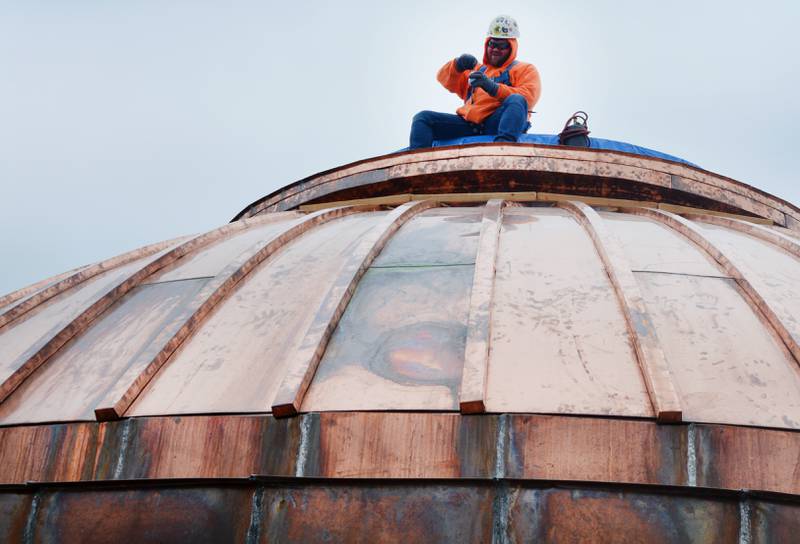 Construction crews work on the copper dome of the First United Methodist Church, which is a contributing building in Newton's downtown historic district.