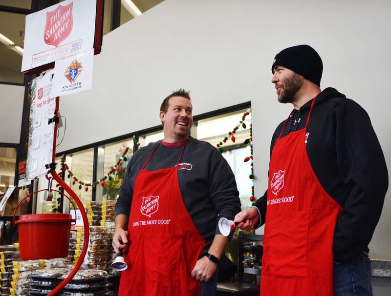From left: Josh McNeer and Matthew Riney, members of the Knights of Columbus, ring bells for the Salvation Army on Dec. 6 inside the Hy-Vee in Newton.