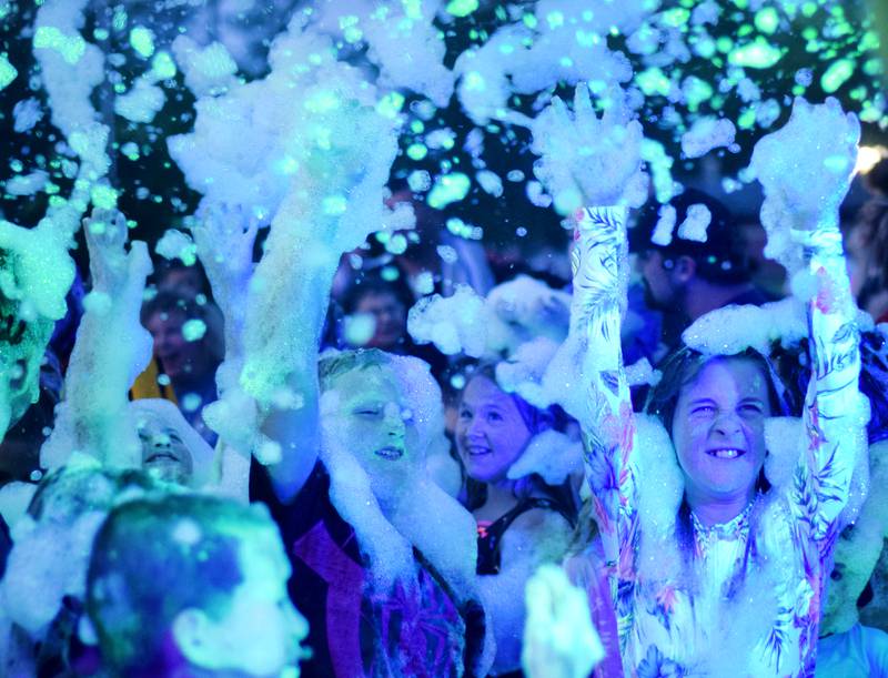 Kids participate in Driving Cap Entertainment's UV Glow Foam Party during Newton Fest on June 9 in Maytag Park in Newton.