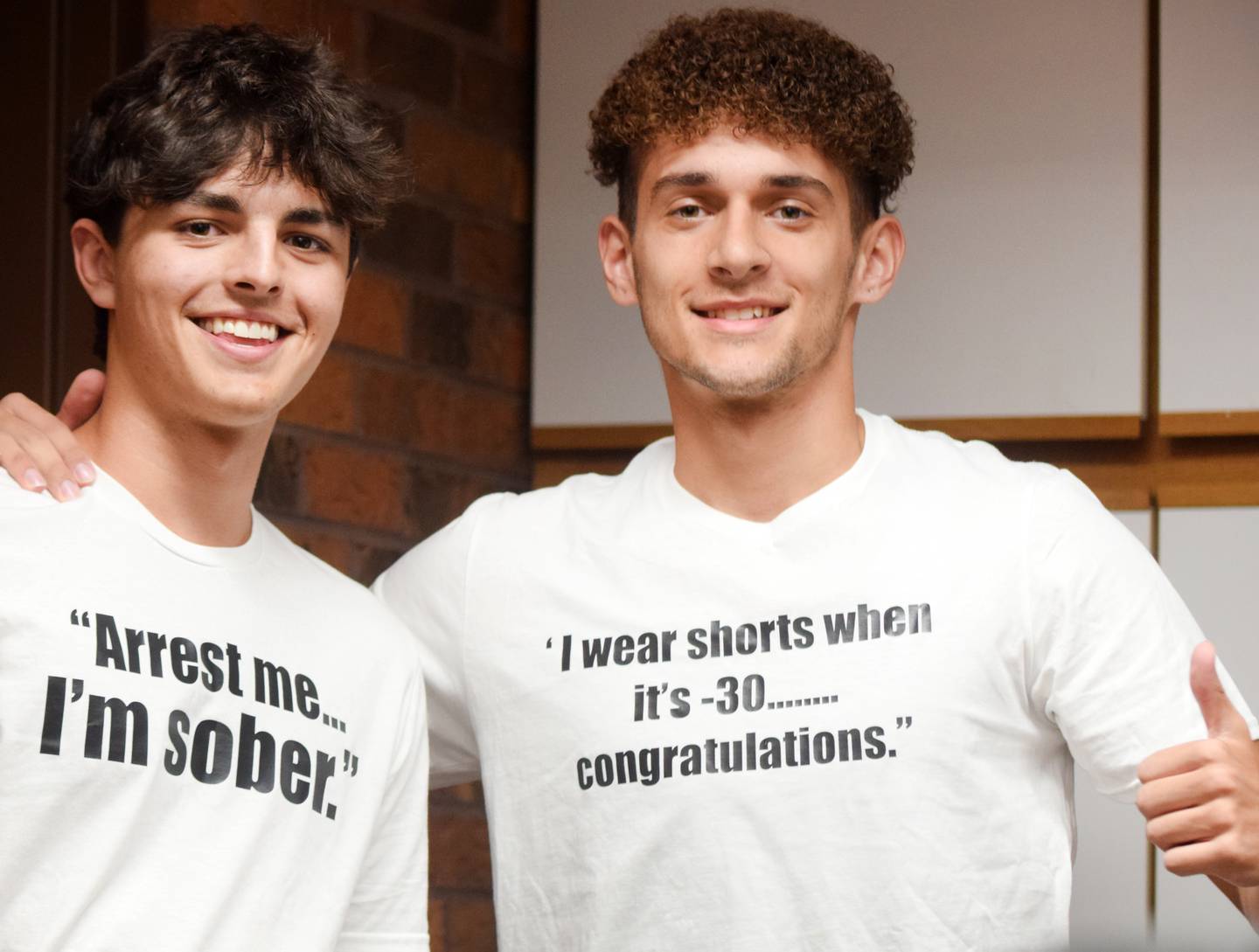 Tayvin Galanakis, right, and a friend wear customized T-shirts referencing his traffic stop with Newton Police Department. Galanakis was suspected of driving while under the influence and was placed in handcuffs. When he was tested at the station, it was determined he was not impaired or under the effects of drugs or alcohol.