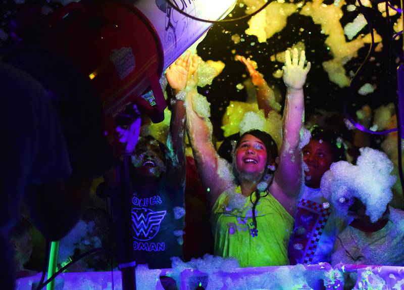 Kids enjoy the return of the Glow Foam Party – which featured two cannons this year – during Newton Fest on June 7 at Maytag Park.
