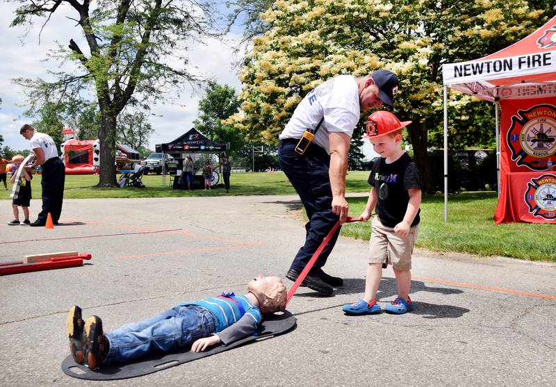Kids participate in obstacle courses and take a try at the fire hose during Safety Fest on June 8 in Maytag Park. Safety Fest is regularly organized by the Newton Fire Department.