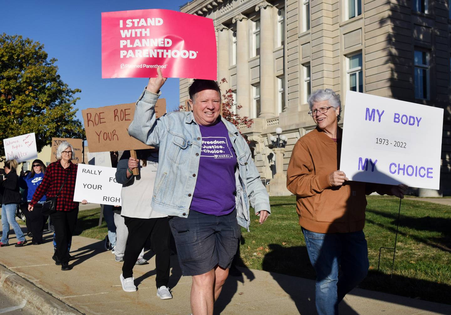 Demonstrators rallying for women's rights march around the town square on Oct. 22 in downtown Newton.