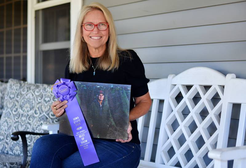 Amy Doerring, of Newton, showcases her award-winning photo named "Parts Collector," which earned Best of Show this year at the Iowa State Fair.