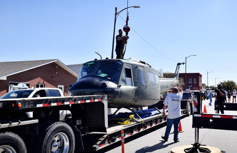 Crews from Midwest Aerospace and Dave's Crane & Wrecker Service help lift a Huey helicopter on Sept. 30 in Baxter.