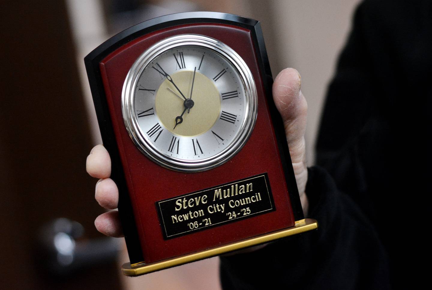 Steve Mullan shows off his timepiece he received for his service to the Newton City Council.