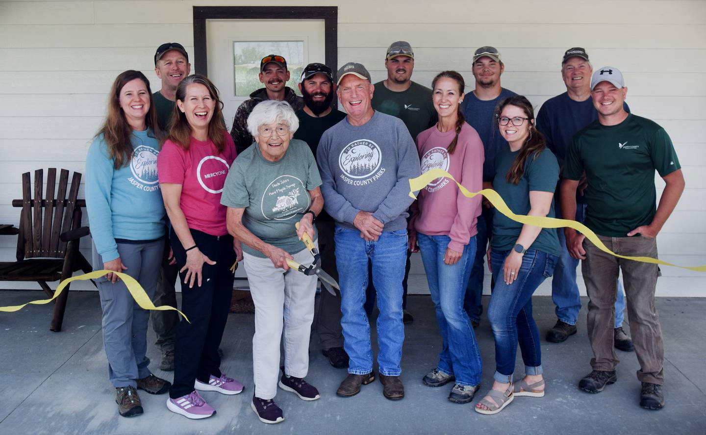 Jasper County Conservation staff and board members participate in a ribbon cutting of the new Bison Ridge Campground and Coneflower Cottage, which features a number of modern-style campsites and a new cabin that is available for rent at Mariposa Park.