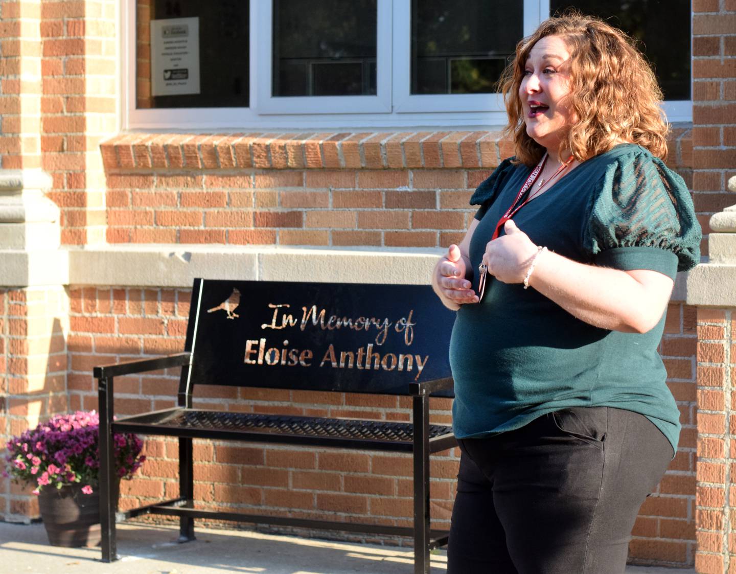 Miranda Bratland, a third grade teacher at Emerson Hough, speaks about her mentor, Eloise Anthony, during a bench dedication on Sept. 13 in Newton.