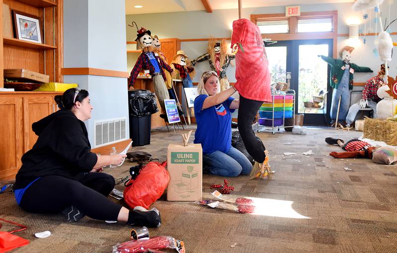 Sara Penning and Samantha Hayden of Chevron REG ready their scarecrow for the second annual Fall Fest and Scarecrow Walk held Oct. 12 at the Newton Arboretum and Botanical Gardens.