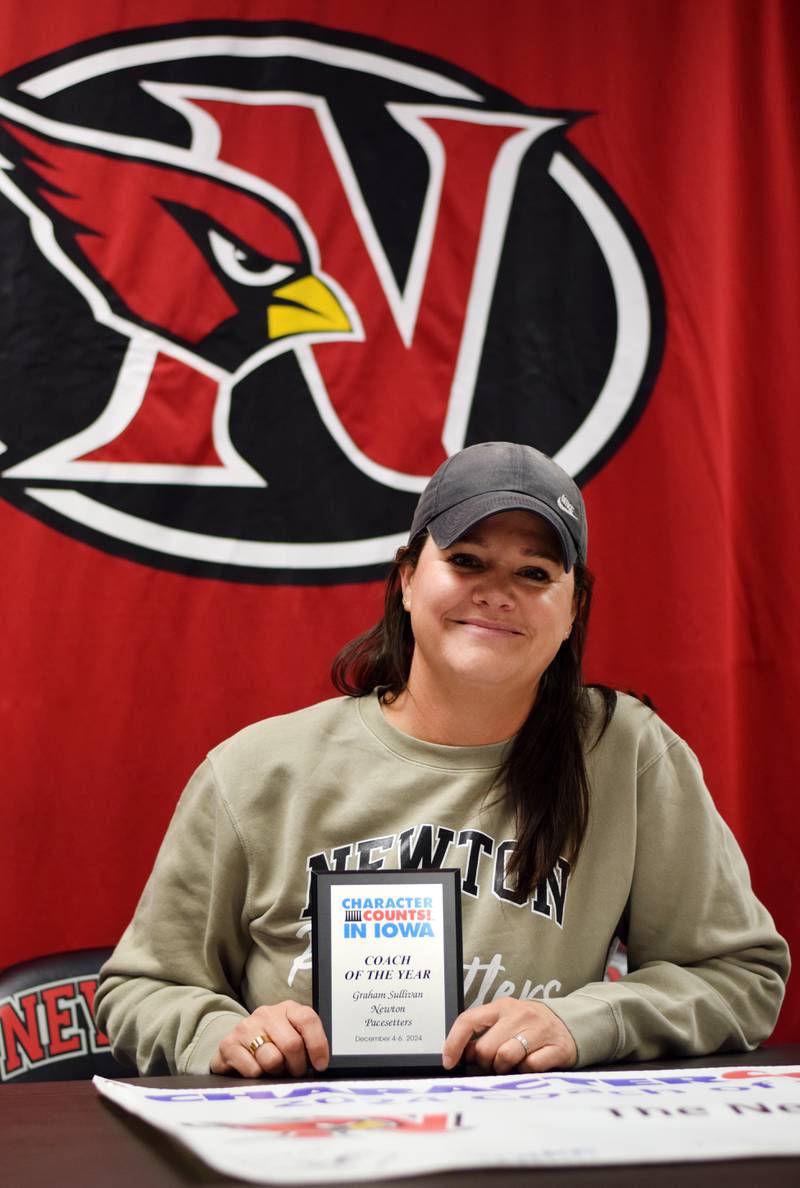Graham Sullivan, head coach of the Newton Pacesetters, shows off the Character Counts Coach of the Year Award she earned at state competition back in December 2024.