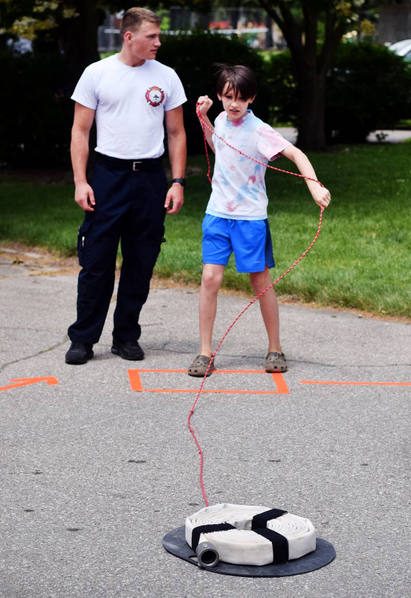 Kids participate in obstacle courses and take a try at the fire hose during Safety Fest on June 8 in Maytag Park. Safety Fest is regularly organized by the Newton Fire Department.
