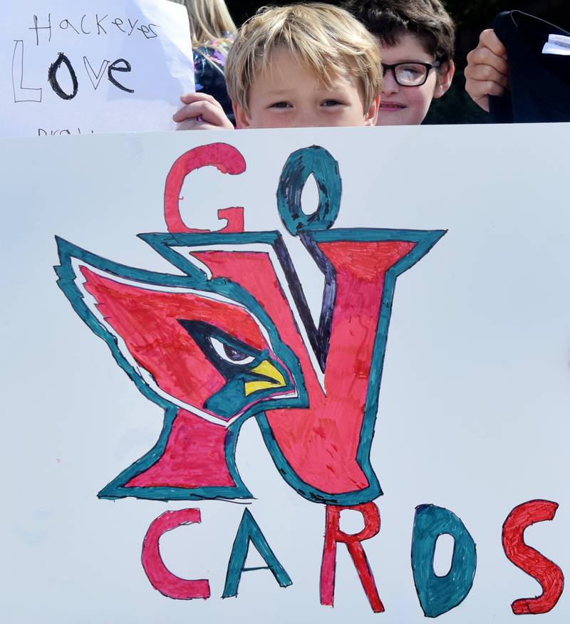 Students wearing Cyclone and Hawkeye – and Cardinal – apparel pose for pictures on Sept. 4 outside Berg Middle School. The whole study body was invited to welcome RVTV to town.