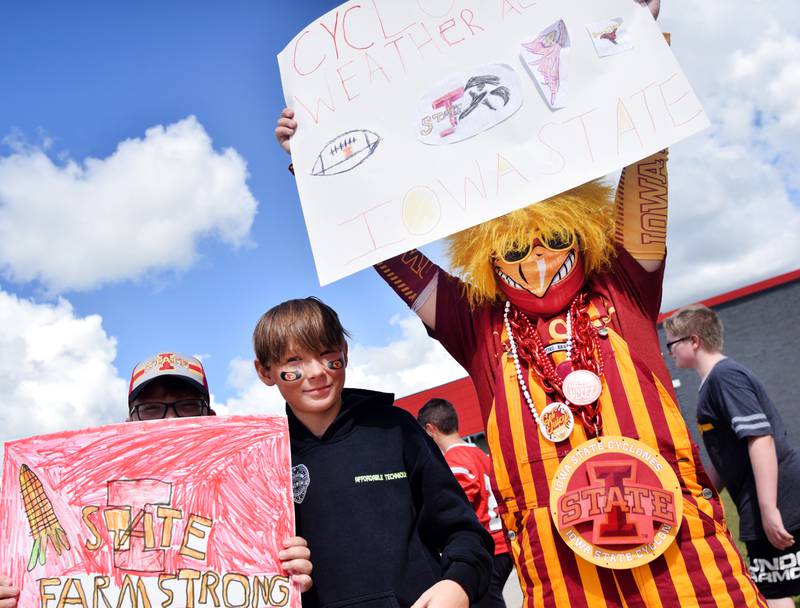 Students wearing Cyclone and Hawkeye apparel pose for pictures on Sept. 4 outside Berg Middle School. The whole study body was invited to welcome RVTV to town.