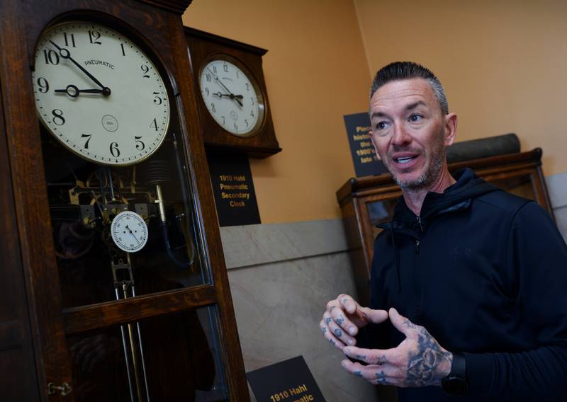 Jasper County Maintenance Director Adam Sparks explains how the 1910 Hahl pneumatic master clock operates alongside its secondary clock. The master clock was recently restored so that it could still operate using compressed air.