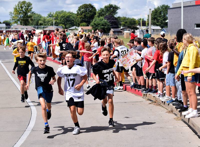 Students Berg Middle School run a lap to hype up their classmates on Sept. 4 while dressed in Hawkeye and Cyclone gear in preparation for RVTV coming to town.