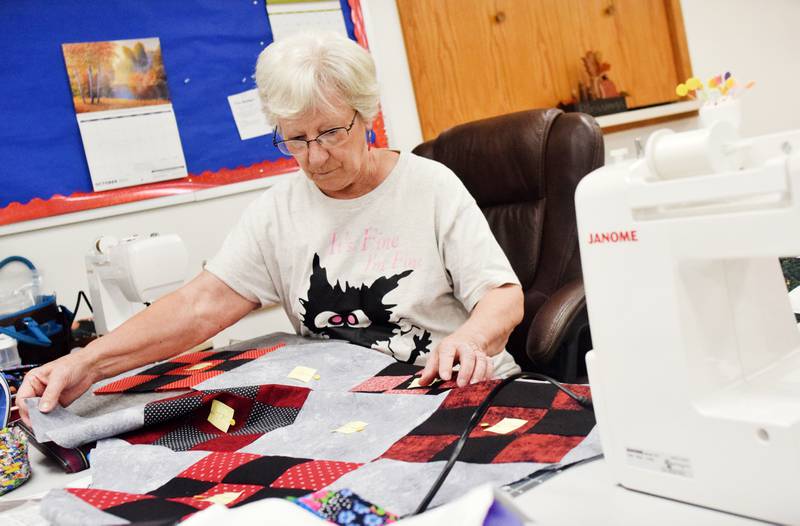 Members of the 1/4-Inch Quilters prepare for the upcoming quilt auction that will be held 6 p.m. Nov. 10, 2023 at the DMACC Newton Campus. The auction is a fundraising for the Salvation Army.