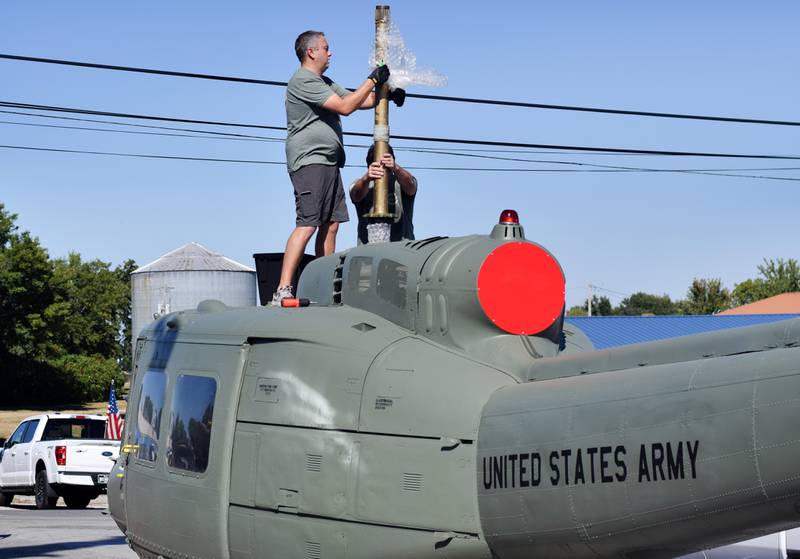 Crews from Midwest Aerospace prepare a  Huey helicopter monument on Sept. 30 in Baxter.