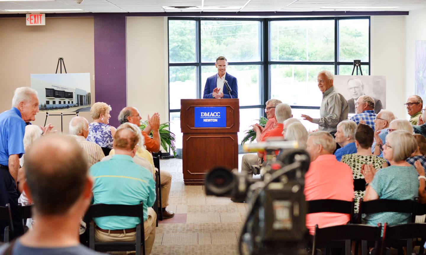 Scott Bennett, the son of Carroll Bennett and past president of the DMACC Foundation Board of Directors, recognizes past DMACC leaders during a dedication ceremony July 8 in the first building of the DMACC Newton Campus, which has now been named the Carroll Bennett Building.