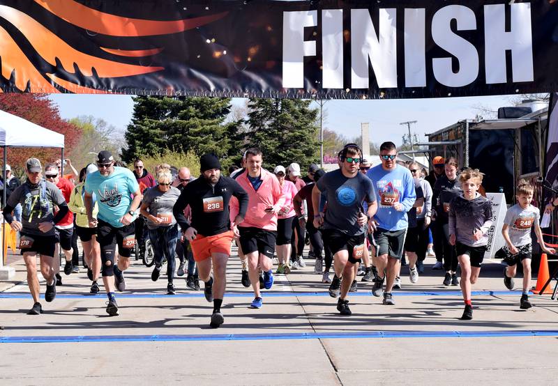 Runners, walkers and young bikers take off for the Run For Her Life 5K organized by nonprofit Phoenix Phase Initiative on April 29 at Legacy Plaza in Newton.