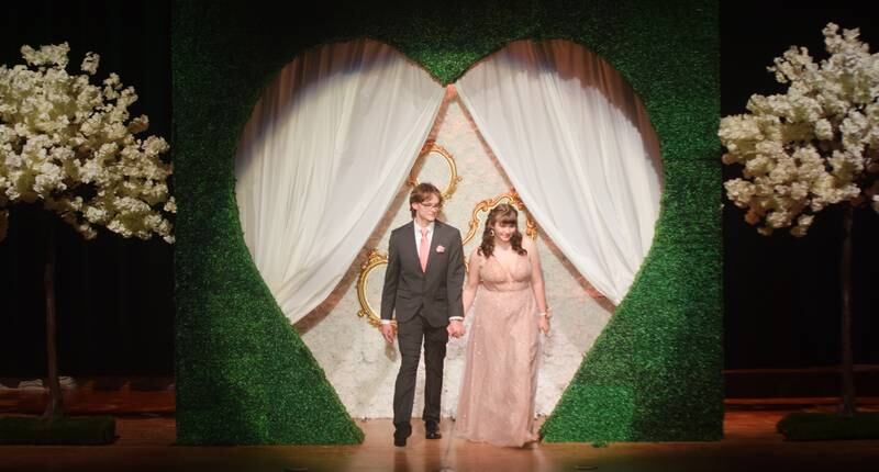 High schoolers pose for photographs before and after entering the auditorium for prom night on Aug. 15 at the Newton High School. Cardinals met for photos at a heart-shaped display on the stage before enjoying the festivities of prom night.