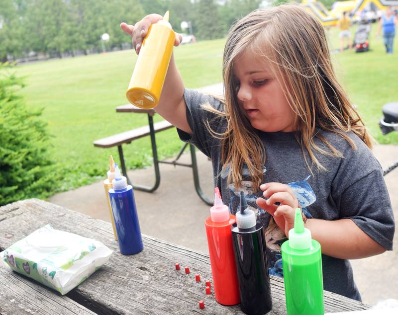 Iowa State University Extension and Outreach hold a spin art bike activity during Newton Fest on Saturday, June 10 at Maytag Park.