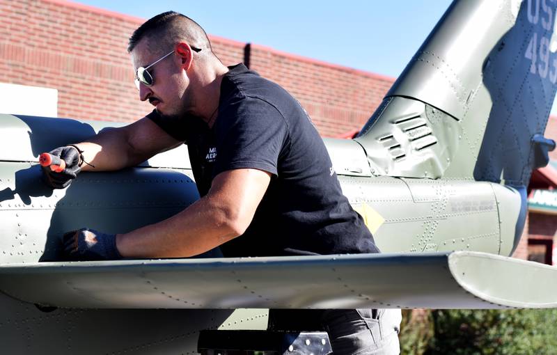 Luke Schreiber of Midwest Aerospace prepares a Huey helicopter monument on Sept. 30 in Baxter.