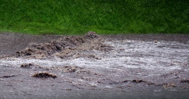 Floodwaters on May 21 rush through an overflowed Cherry Creek through Westwood Golf Course near Newton. The lower areas of the course were completely flooded, and the waters eventually overtook a number of homes in the nearby Lambs Grove.
