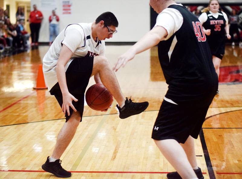 Thomas Russell pulls off a trick before sinking a two-point shot during The Big Game on April 19 at Newton High School.