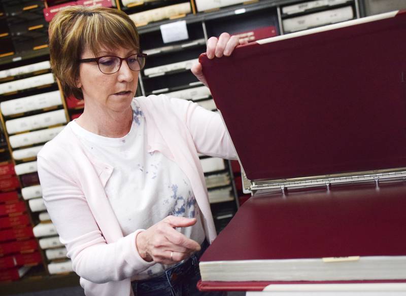 Jasper County Recorder Denise Allan inspects vitals April 15 on her second floor office space inside the courthouse in Newton. The board of supervisors on April 12 authorized the relocation of the recorder's office to the treasurer's office and DMV, which will move into the new administration building when it is finally completed.