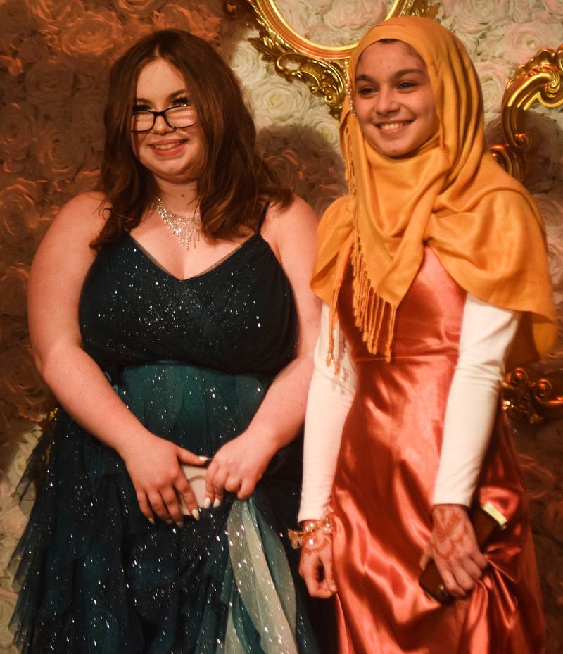 High schoolers pose for photographs before and after entering the auditorium for prom night on Aug. 15 at the Newton High School. Cardinals met for photos at a heart-shaped display on the stage before enjoying the festivities of prom night.